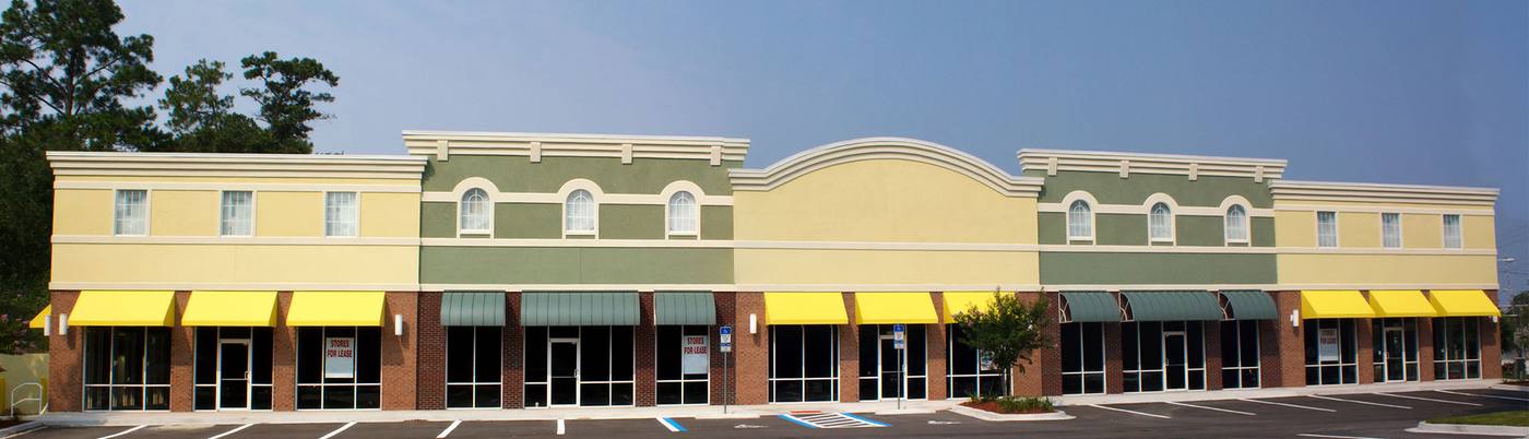 Retail storefronts with yellow and green awnings